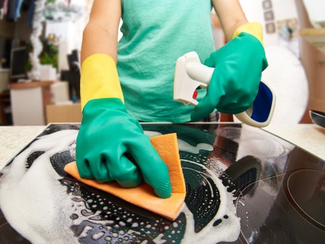 Carpet cleaning staff using protective gloves and footwear during a Raynes Park job
